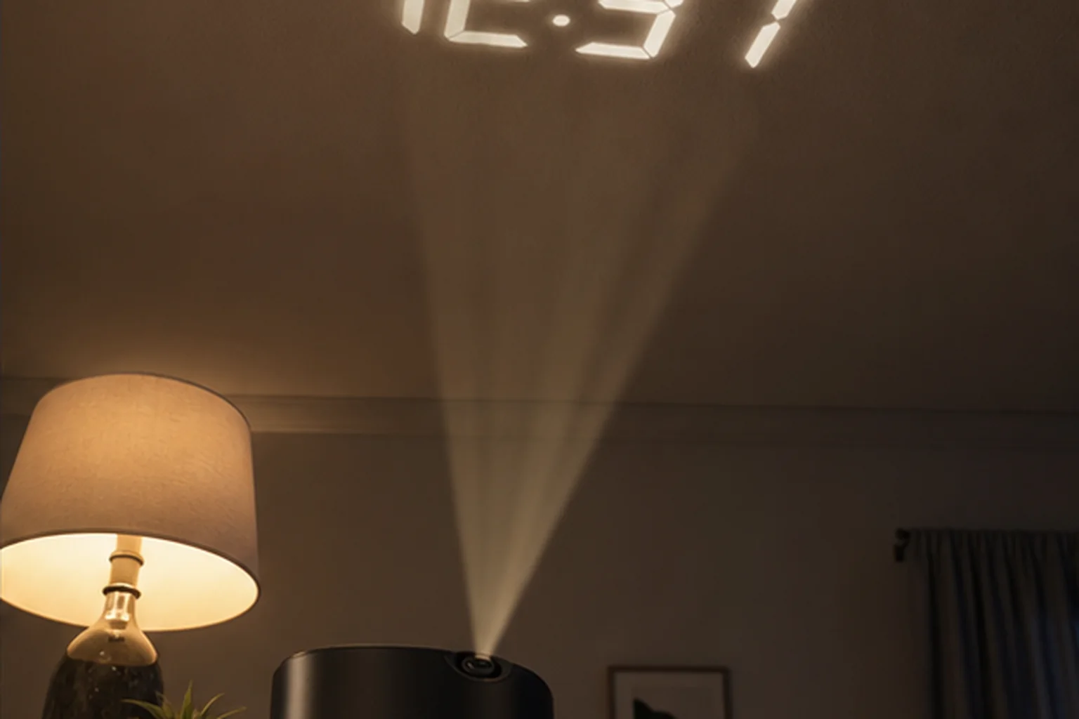 Projection alarm clock displaying the time on a bedroom ceiling