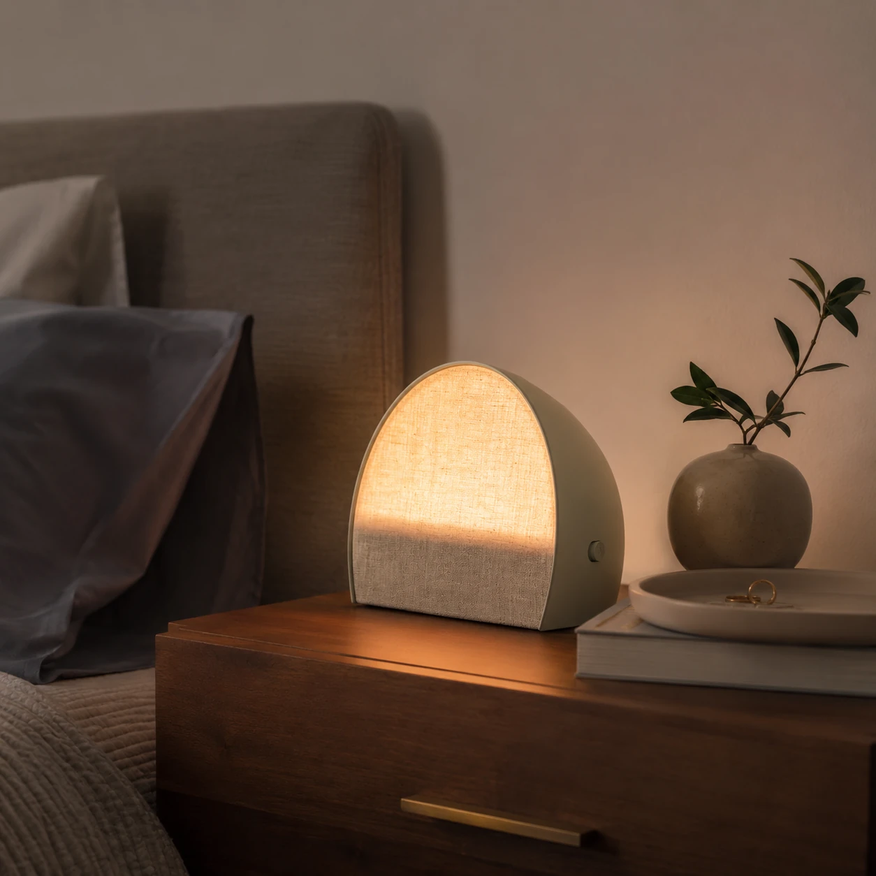 Hatch Restore 2 in a minimalist bedroom evening setup with a soft ambient glow