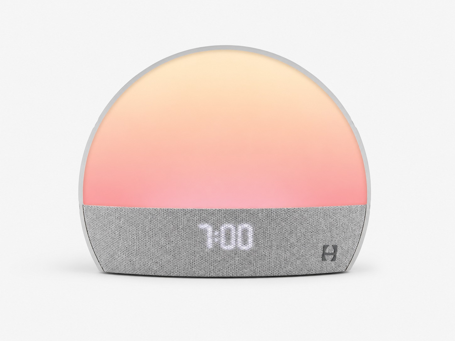 Front view of Hatch Restore Smart Alarm Clock with glowing sunrise light and fabric speaker