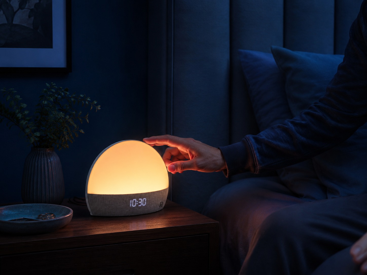 Hatch Restore Smart Alarm Clock used at night with warm light and touch control
