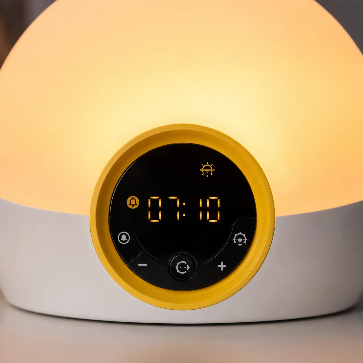 Front-facing product photo of the Lumie Bodyclock Rise100 alarm clock with warm white glow and digital display on a neutral background.