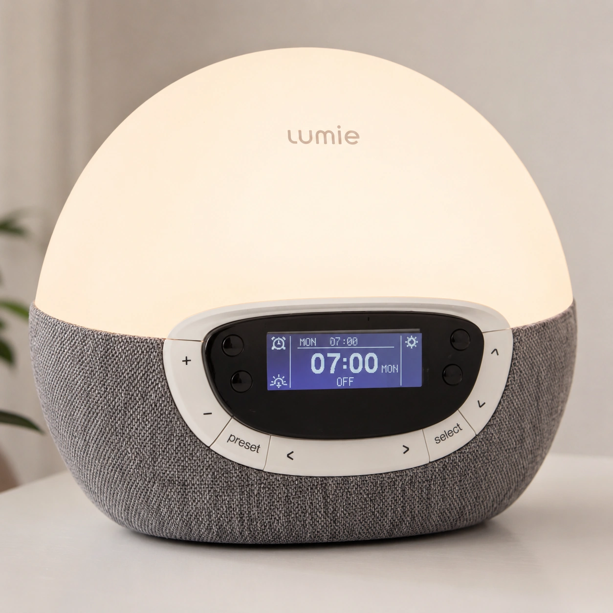 Lumie Bodyclock Rise300 modern alarm clock on a bedside table